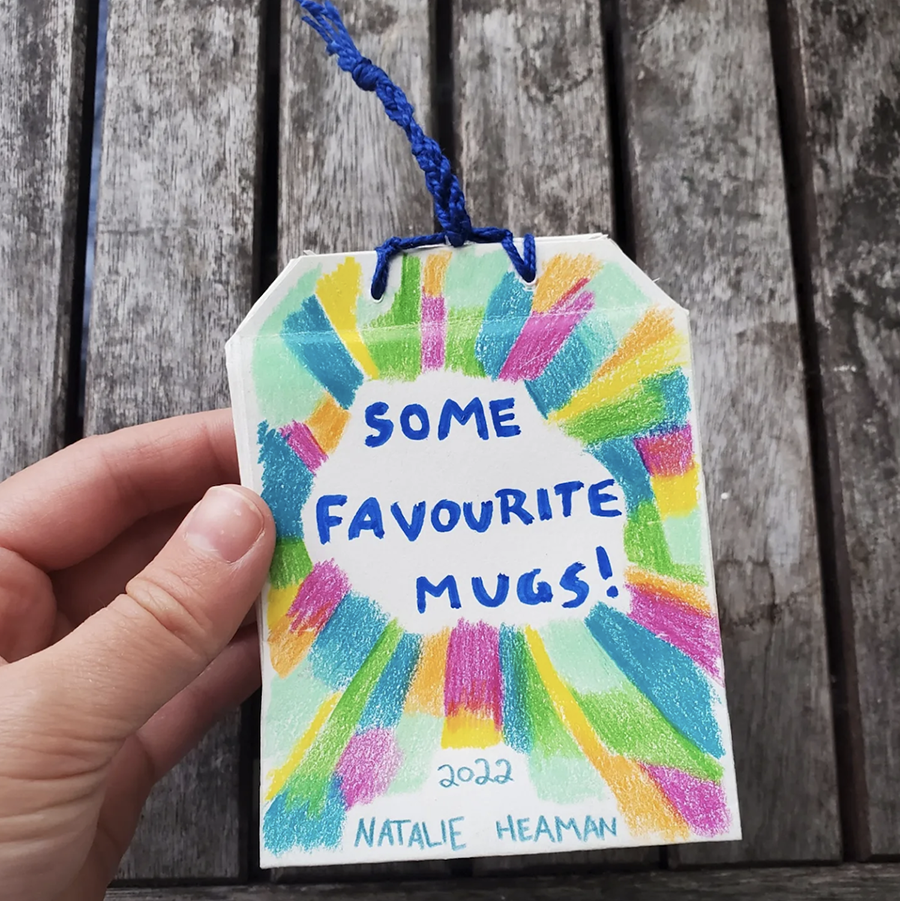 Image of a small booklet that could fit in your palm. The shape is similar to a teabag, and the cover reads "some favourite mugs!"